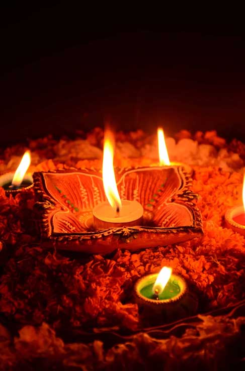 Indian couple with diya, sweets and gifts while celebrating Diwali,  Deepavali or Dipavali festival - Stock Image - Everypixel