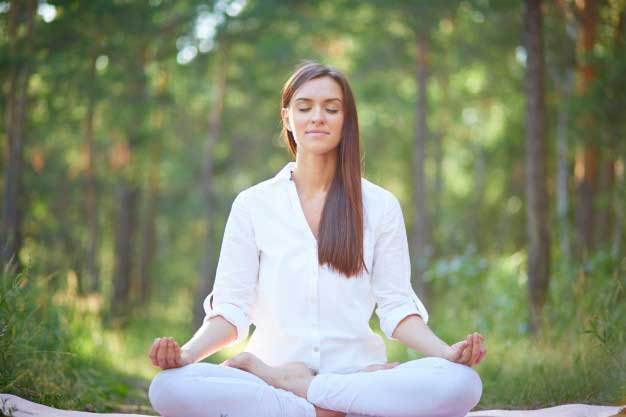 meditating girl in park doing  yoga for menopause