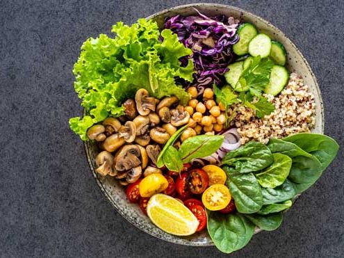 quinoa-mushrooms-lettuce-red-cabbage-spinach-cucumbers-tomatoes-bowl-buddha-dark-top-view_127032-1963