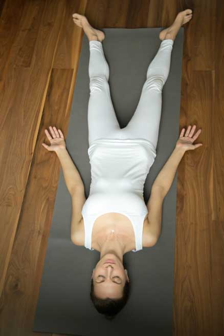 white dress girl doing shavasana.